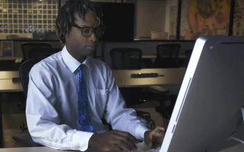 Stock Video Man Working On Computer In An Office At Nigh Animated Wallpaper