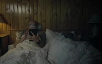 Stock Video Man Watching The Tablet In The Bedroo Animated Wallpaper