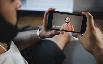 Stock Video Man Watches Social Media Video On Mobile Scree Animated Wallpaper