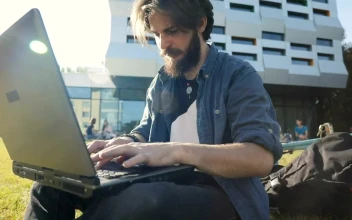 Stock Video Man Typing On Laptop Outside Smiles In Triump Animated Wallpaper