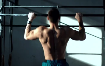 Stock Video Man Training On The Bars In The Gy Animated Wallpaper