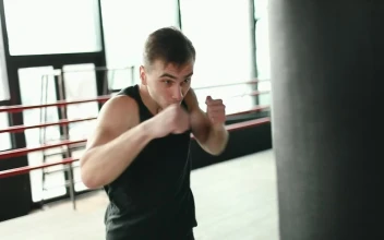 Stock Video Man Training On Punching Bag In Boxing Rin Animated Wallpaper