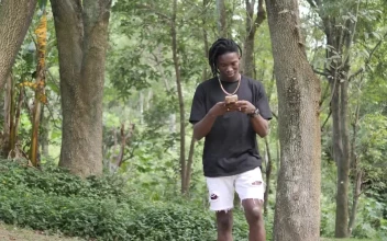 Stock Video Man Texting On Cell Phone While Walking In Par Animated Wallpaper
