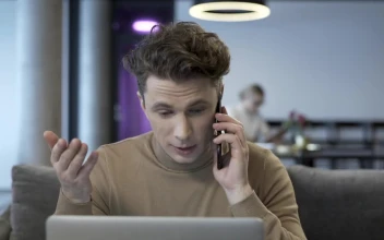 Stock Video Man Talking On The Phone While Working On The Compute Animated Wallpaper
