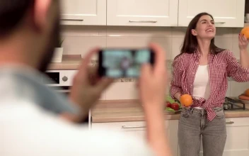 Stock Video Man Takes Social Media Photo Of Woman On Mobile I Animated Wallpaper