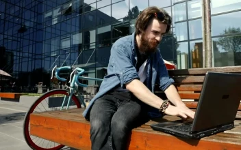 Stock Video Man Surfs Internet On Laptop From Street Benc Animated Wallpaper