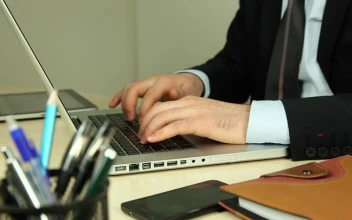 Stock Video Man Sitting On A Couch Working On A Lapto Animated Wallpaper