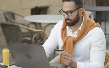 Stock Video Man Shops Online In Cafe And Pays With Credit Car Animated Wallpaper