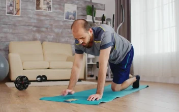 Stock Video Man Sets Exercise Timer On Mobile Phone For Yoga Pos Animated Wallpaper