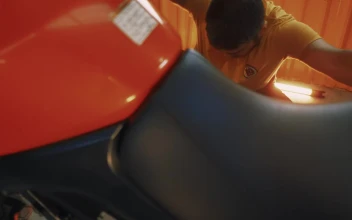 Stock Video Man Repairing His Motorcycle In A Garag Animated Wallpaper