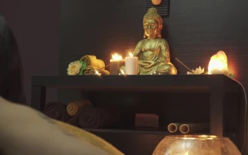 Stock Video Man Praying To Candle Lit Buddh Animated Wallpaper