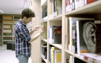 Stock Video Man Looking For A Book In The Librar Animated Wallpaper
