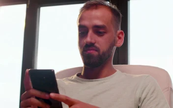 Stock Video Man Looking At His Cell Phone While Smilin Animated Wallpaper