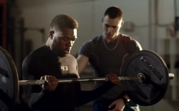 Stock Video Man Lifting Weights Supported By His Traine Animated Wallpaper