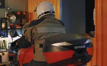 Stock Video Motorcyclist Arriving At A Mechanical Workshop