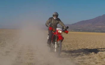Stock Video Motorcyclist On A Red Motorcycle In The Desert