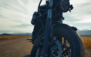 Stock Video Motorcyclist Riding A Motorcycle Parked In A Desert