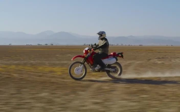 Stock Video Motorcyclist Traveling Through The Desert