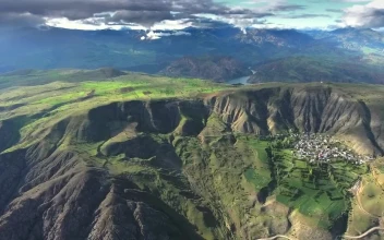 Stock Video Mountain Landscape With A Village Crop Fields And A River