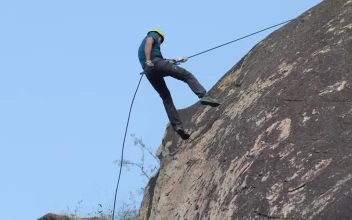 Stock Video Mountaineer Descending From A Rocky Mountain