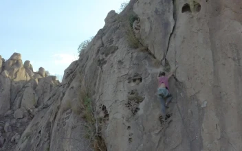 Stock Video Mountaineer Girl Climbing A Steep Rocky Mountain