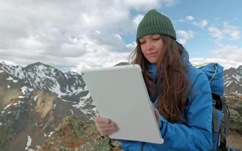Stock Video Mountaineer Girl Using A Tablet In The Mountains
