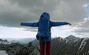 Stock Video Mountaineer Raising Hands On Top Of A Mountain