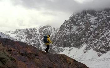 Stock Video Mountaineer Walking On A Cliff In A Winter Mountain Range