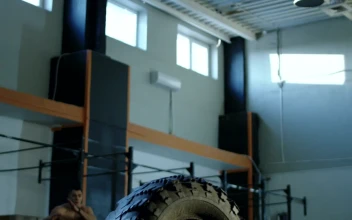 Stock Video Muscular Man Jumping A Tire In The Gym