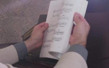 Stock Video Musician Looking For A Page In A Score Book
