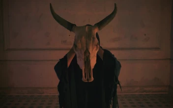 Stock Video Mysterious Person In Black Robe Holding The Skull Of A