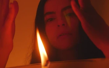 Stock Video Mysterious Woman Appreciating The Flame Of A Candle