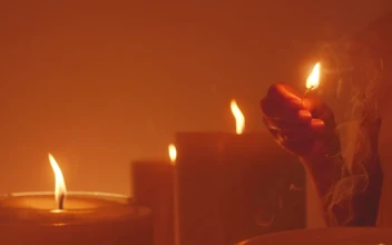 Stock Video Mysterious Woman Lighting A Huge Candle
