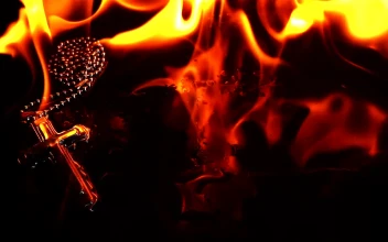Stock Video Necklace Of A Burning Crucifix Close Up