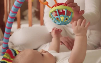 Stock Video Newborn Baby Plays With A Toy
