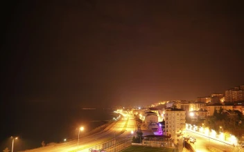 Stock Video Night To Day Time Lapse Of A City By The