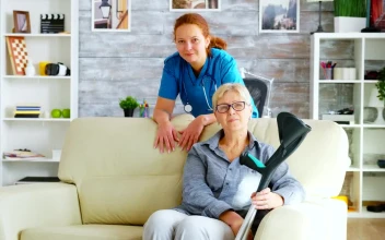 Stock Video Nurse Stands With Elderly Patient Sitting On Sofa