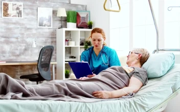 Stock Video Nurse Talks With Woman Laying In Hospital Bed