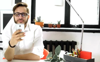 Stock Video Office Man Texting And Drinking Coffee At The Office