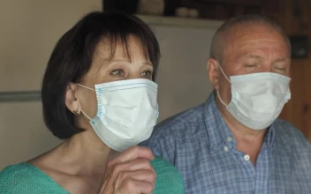 Stock Video Old Couple Taking Off Their Masks At Home