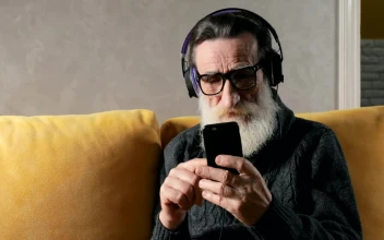 Stock Video Old Man Listens To Music With Headphones On Sofa