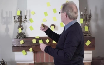 Stock Video Old Man Placing Notes On The Wall For His Memory
