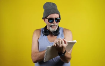 Stock Video Old Man Writing Be Yourself On A Notebook