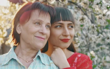 Stock Video Old Mother With Her Young Daughter In A Flower Garden