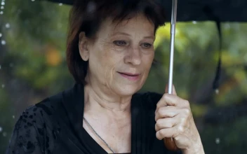 Stock Video Old Sad Woman At A Funeral While Raining