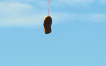 Stock Video Old Shoes Hanging On An Electric Wire