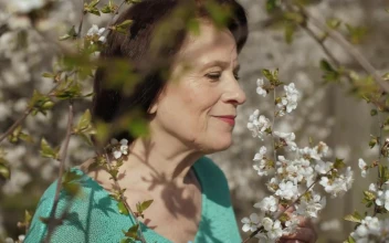Stock Video Old Woman Smelling Flowers From Her Garden
