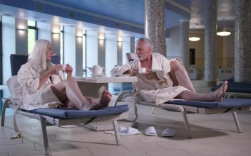 Stock Video Older Couple Having A Drink By The Pool
