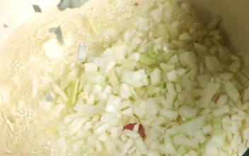 Stock Video Onion Slices Falling Into The Pan In Slow Motion