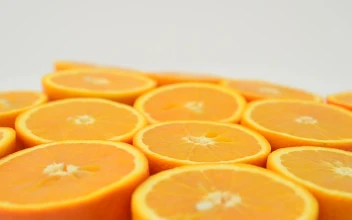 Stock Video Orange Halves Spinning With A White Background